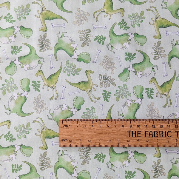 A repeating pattern featuring green dinosaurs, pale green leaves, and small white bones on a light green background.
