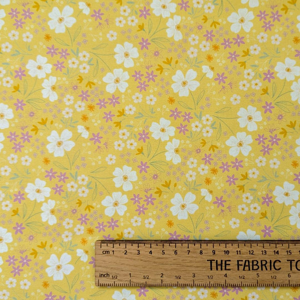 Songs of Spring on Sunshine Yellow - A cheerful floral pattern with white, pink, and yellow flowers on a warm yellow background.