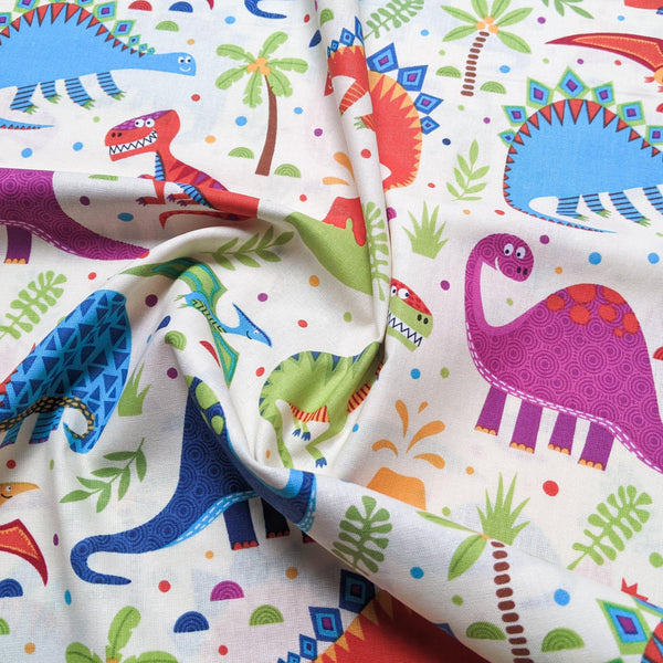 Multi coloured dinosaurs on cream background - 100% cotton - Craft Cotton Co
